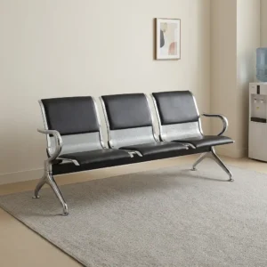 3-seater airport waiting bench with black leatherette padded seats, perforated chrome backrests, chrome side armrests, and angled metal beam legs.