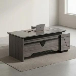 1800mm gray wood grain L-shaped executive desk with decorative central modesty panel, side storage return unit, and desktop cable grommet.