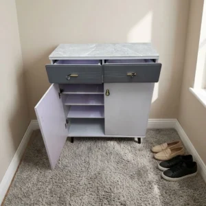 Gray and white 2-door shoe storage cabinet with marble-look top, two upper drawers with crystal knobs, internal shelves, and tapered legs.