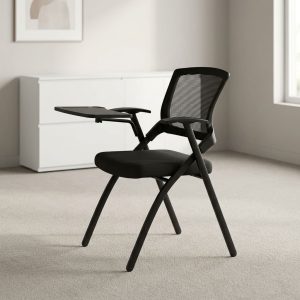 Black mesh training chair with integrated right-hand flip-up writing pad desk tablet, padded seat, T-style armrests, and folding A-frame steel legs.