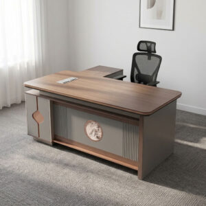 1800mm executive L-shaped office table with dark wood top, integrated cable outlet, textured grey modesty panel with decorative oval emblem, and side cabinet return.